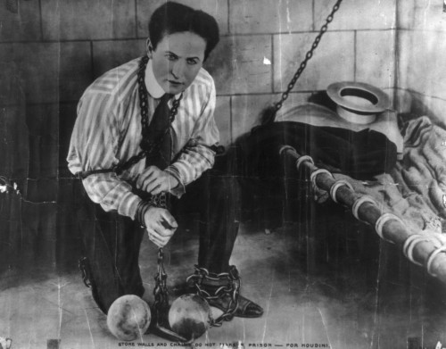 The caption reads: "Stone walls and chains do not make a prison--for Houdini"